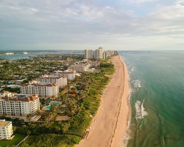 The palm beach coastline and some buildings. 