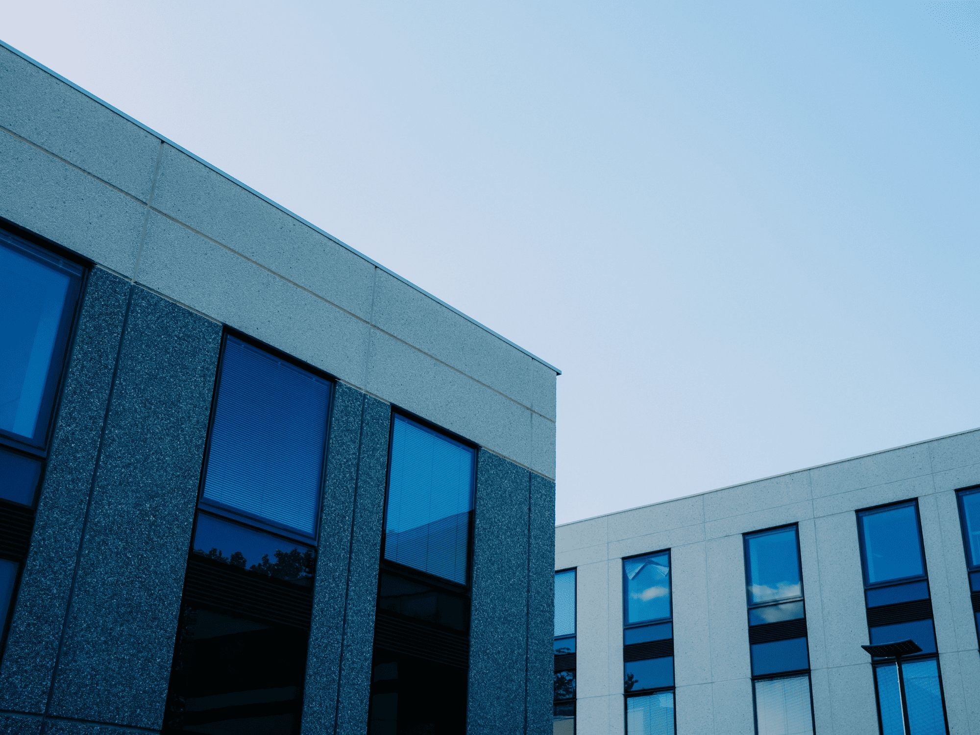 Modern blue glass office building exterior - stock
