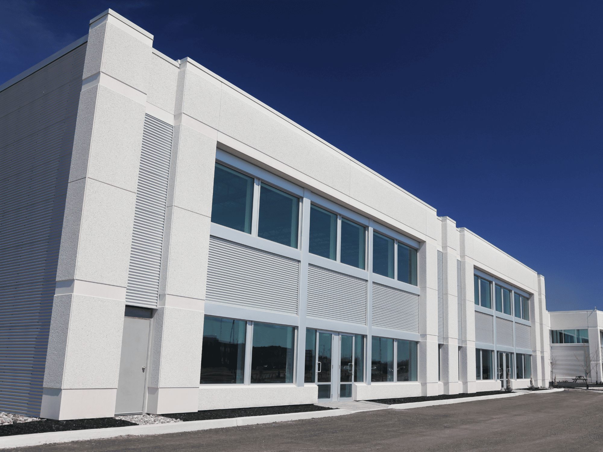 Modern white two story commercial office building - stock