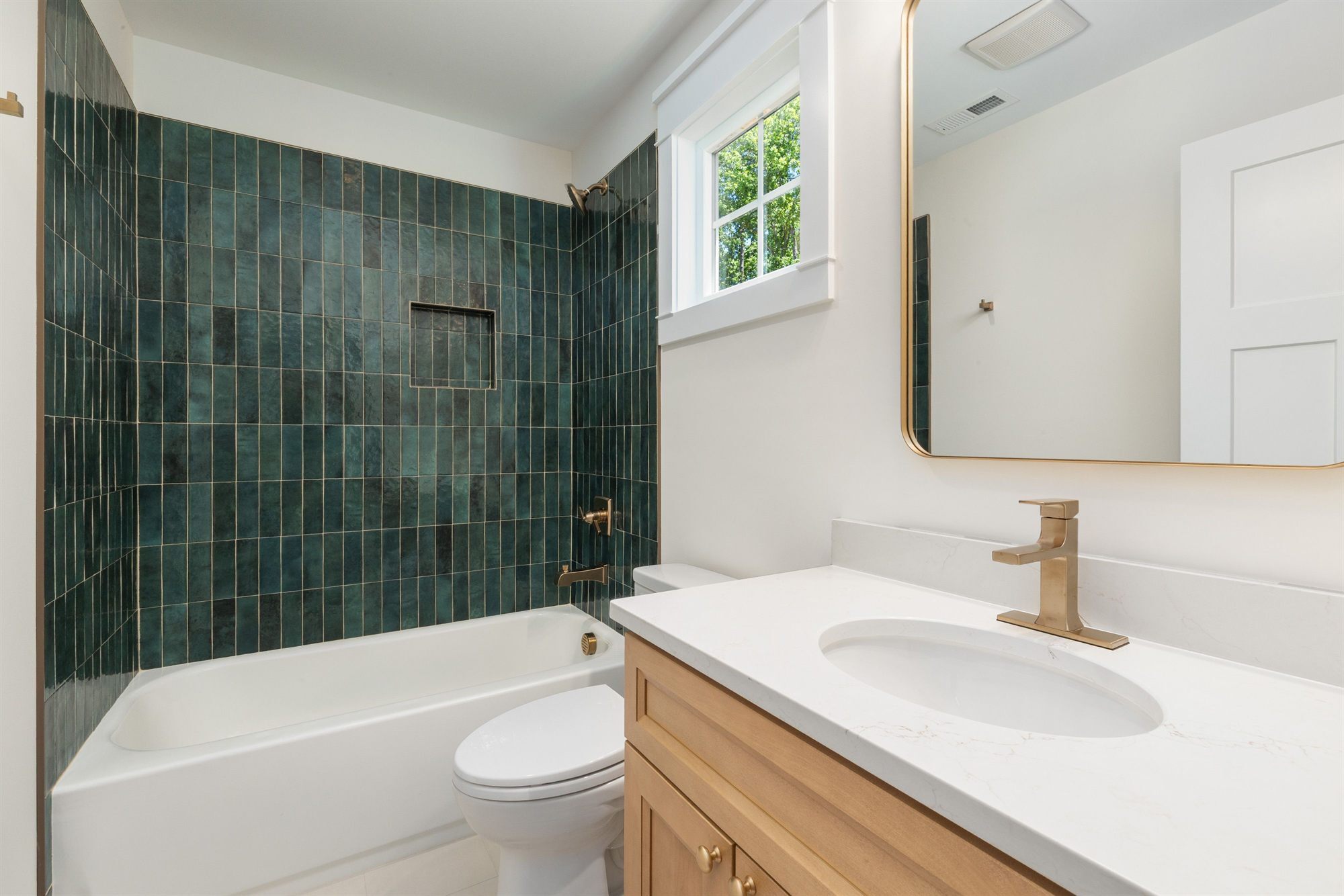 bathroom-green-tile-gold-fixtures-stock
