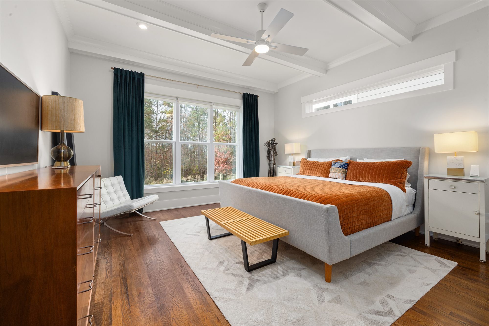 bedroom-orange-bedding-teal-curtains-stock
