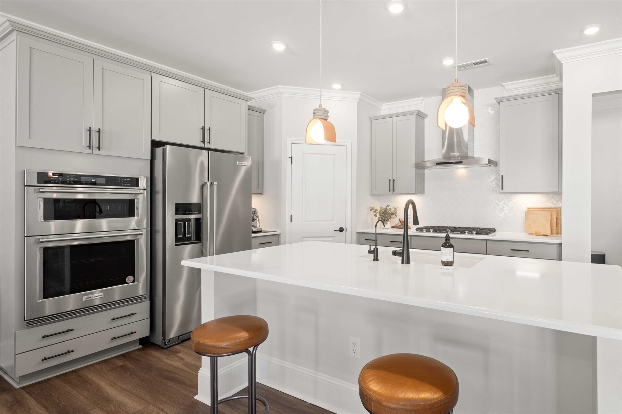 gray-kitchen-island-leather-stools-stock