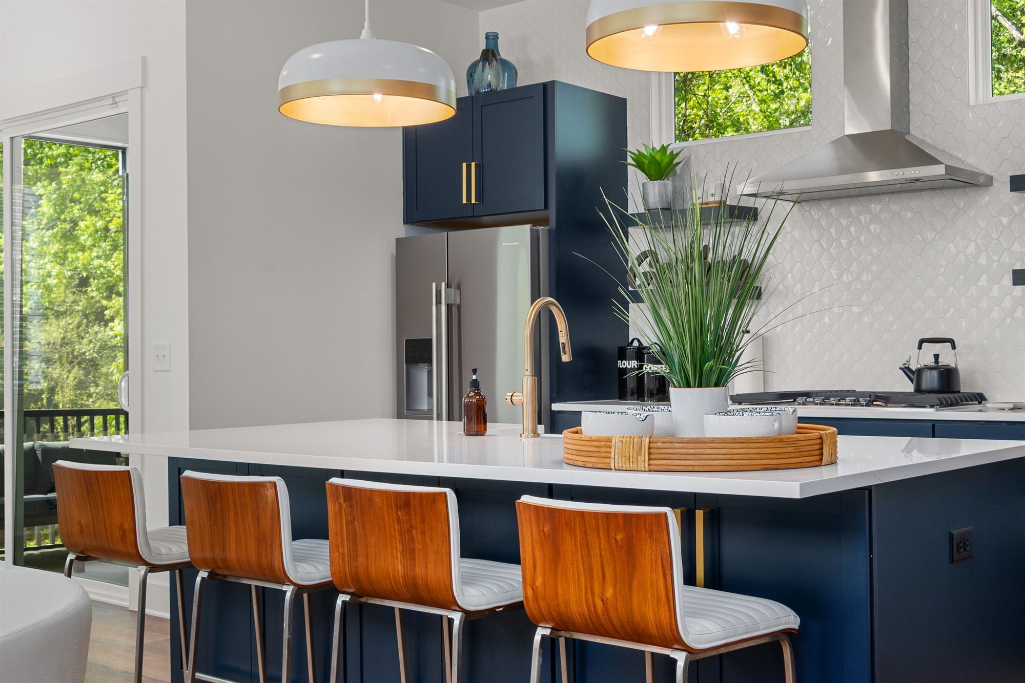 navy-kitchen-island-gold-faucet-stock